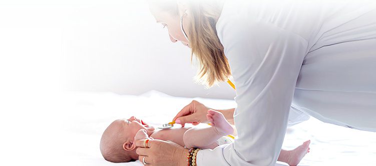 Young Doctor Examining Baby Mobile